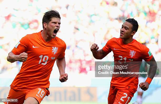 Klaas-Jan Huntelaar of the Netherlands celebrates scoring his team's second goal on a penalty kick in stoppage time with Memphis Depay during the...