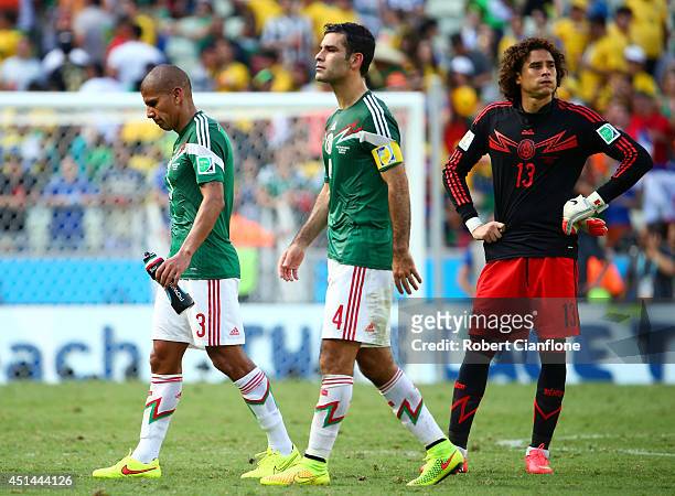 Carlos Salcido, Rafael Marquez and Guillermo Ochoa of Mexico look dected after being defeated by the the Netherlands in the 2014 FIFA World Cup...
