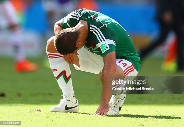 Dejected Javier Hernandez of Mexico looks on after being defeated by the Netherlands 2-1 during the 2014 FIFA World Cup Brazil Round of 16 match...
