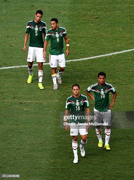 Diego Reyes, Marco Fabian, Javier Hernandez and Giovani dos Santos of Mexico look on after being defeated by the Netherlands 2-1 during the 2014 FIFA...