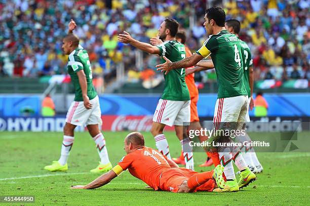 Rafael Marquez of Mexico reacts after a challenge on Arjen Robben of the Netherlands resulting in a yellow card for Marquez and a penalty kick for...