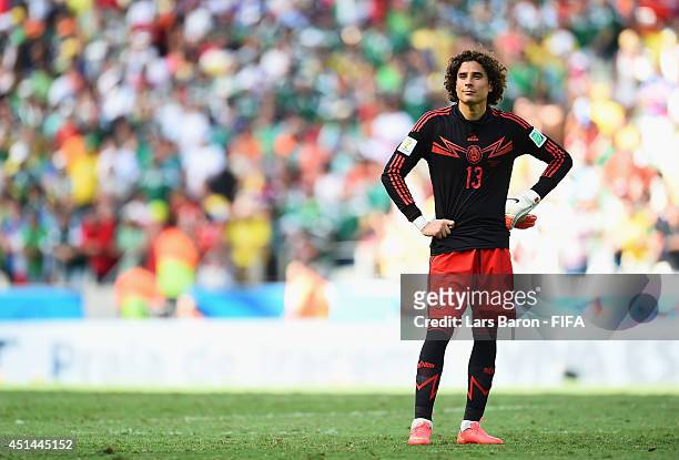 Guillermo Ochoa of Mexico reacts after the 1-2 defeat in the 2014 FIFA World Cup Brazil Round of 16 match between Netherlands and Mexico at Estadio...