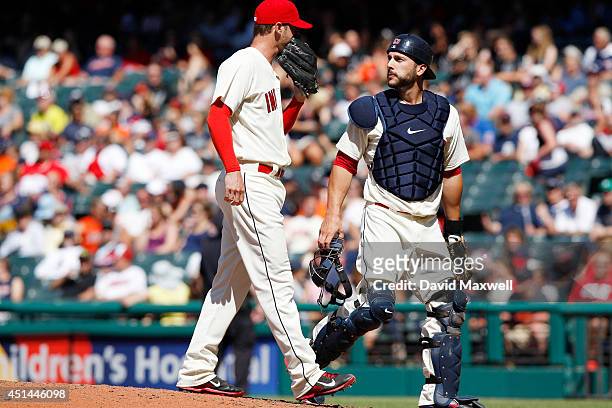 Mark Lowe talks with George Kottaras of the Cleveland Indians on the mound against the Detroit Tigers during the eighth inning of their game on June...