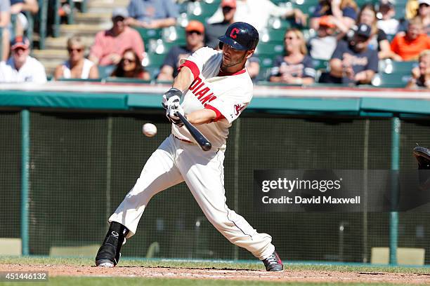 George Kottaras of the Cleveland Indians siingles against the Detroit Tigers during the ninth inning of their game on June 22, 2014 at Progressive...