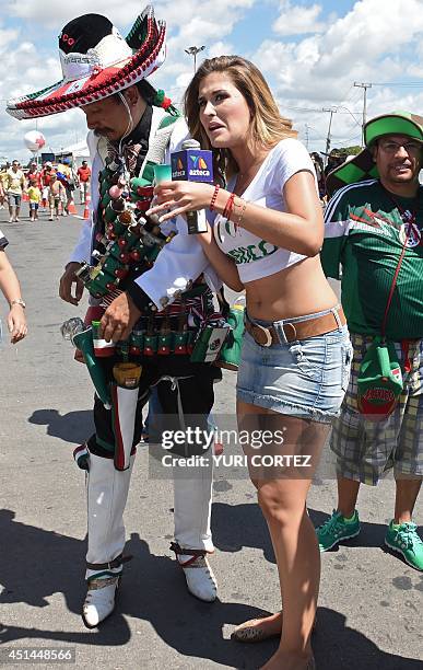 Mariana Gonzalez , a presenter for Mexico's Azteca television channel interviews a Mexican fan outside the Castelao Stadium prior to a Round of 16...