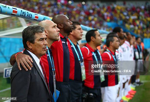 Head coach Jorge Luis Pinto of Costa Rica, team staffs and substitute players line up for the national anthem prior to the 2014 FIFA World Cup Brazil...