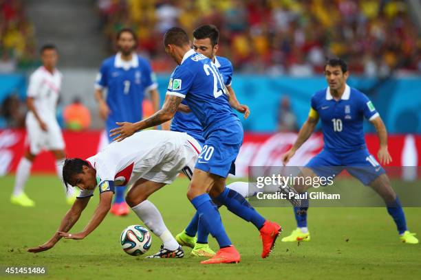 Bryan Ruiz of Costa Rica competes for the ball with Jose Cholevas of Greece during the 2014 FIFA World Cup Brazil Round of 16 match between Costa...