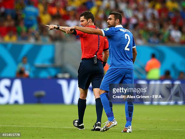 Referee Benjamin Williams and Giannis Maniatis of Greece gesture during the 2014 FIFA World Cup Brazil Round of 16 match between Costa Rica and...