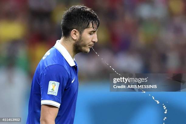 Greece's defender Konstantinos Manolas spits during a Round of 16 football match between Costa Rica and Greece at Pernambuco Arena in Recife during...