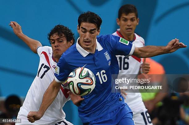 Greece's midfielder Lazaros Christodoulopoulos vies with Costa Rica's midfielder Yeltsin Tejeda during a Round of 16 football match between Costa...