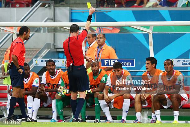 Oscar Granados of Costa Rica is shown a yellow card by referee Benjamin Williams while sitting on the bench during the 2014 FIFA World Cup Brazil...