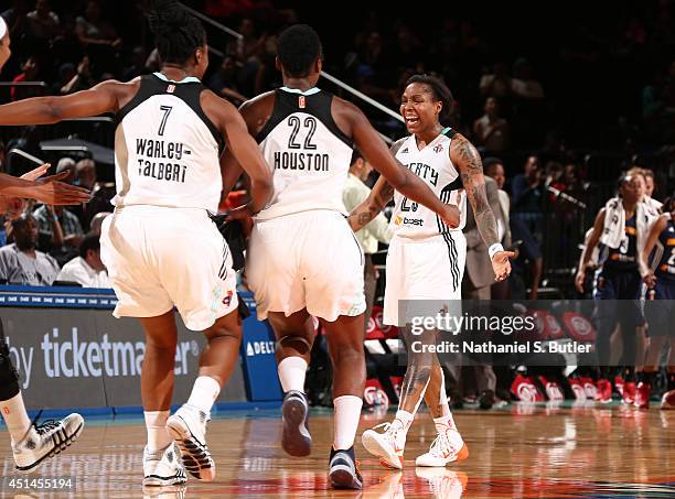 Teammates Avery Warley-Talbert, Charde Houston, and Cappie Pondexter of the New York Liberty celebrate during a game against the Connecticut Sun at...