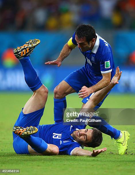Sokratis Papastathopoulos of Greece celebrates scoring his team's first goal with Giorgos Karagounis during the 2014 FIFA World Cup Brazil Round of...