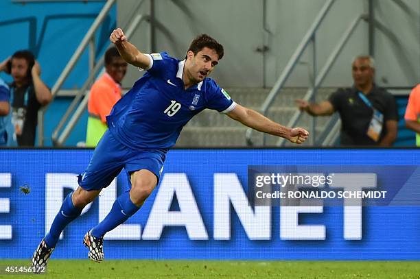 Greece's defender Sokratis Papastathopoulos celebrates after scoring his team's equaliser during the round of 16 football match between Costa Rica...