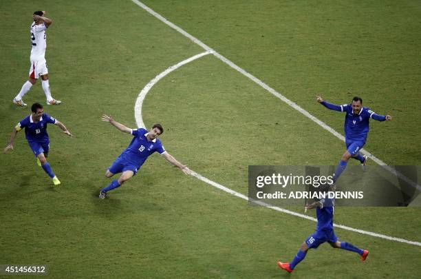 Greece's defender Sokratis Papastathopoulos celebrates with teammates after scoring during a Round of 16 football match between Costa Rica and Greece...