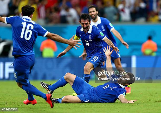 Sokratis Papastathopoulos of Greece celebrates scoring his team's first goal with his teammates Lazaros Christodoulopoulos , Giorgos Karagounis and...