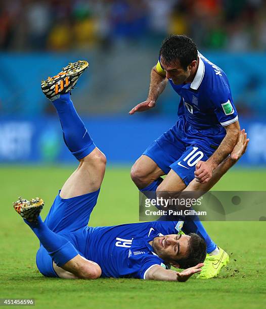 Sokratis Papastathopoulos of Greece celebrates scoring his team's first goal with Giorgos Karagounis during the 2014 FIFA World Cup Brazil Round of...
