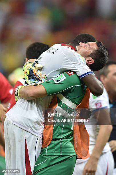 Costa Rica's defender Junior Diaz and goalkeeper Daniel Cambronero celebrate after wining a Round of 16 football match between Costa Rica and Greece...