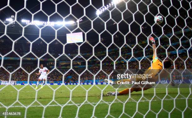 Michael Umana of Costa Rica shoots and scores his penalty kick past Orestis Karnezis of Greece to defeat Greece in a shootout during the 2014 FIFA...