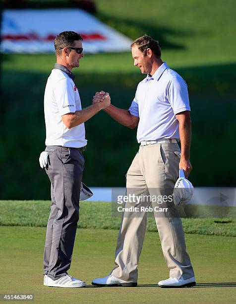 Justin Rose of England shakes hands with Shawn Stefani of the United States after Rose won on the first playoff during the final round of the Quicken...