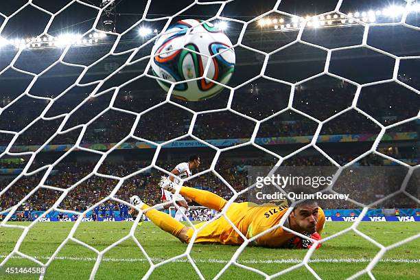 Michael Umana of Costa Rica shoots and scores his penalty kick past Orestis Karnezis of Greece to defeat Greece in a shootout during the 2014 FIFA...