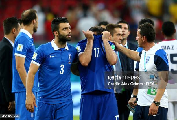 Theofanis Gekas and Giorgos Tzavellas react after the defeat in the 2014 FIFA World Cup Brazil Round of 16 match between Costa Rica and Greece at...