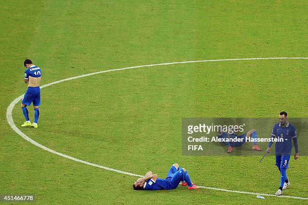 Giorgos Karagounis of Greece reacts with his team mate Konstantinos Mitroglou and others after being defeated by Costa Rica in a penalty shootout...