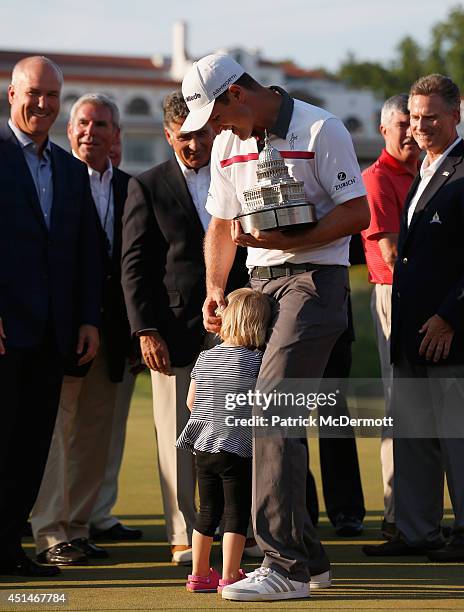 Justin Rose of England is hugged by his daughter Charlotte after winning the Quicken Loans National at Congressional Country Club on June 29, 2014 in...