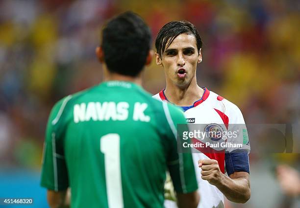 Bryan Ruiz of Costa Rica reacts with goalkeeper Keylor Navas after a made penalty kick in a shootout during the 2014 FIFA World Cup Brazil Round of...
