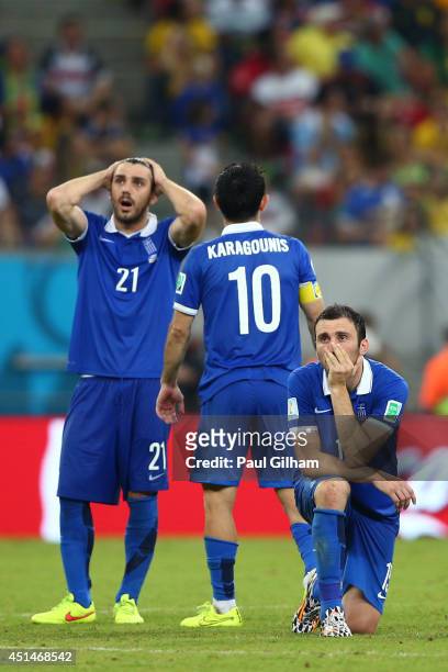 Konstantinos Katsouranis, Giorgos Karagounis and Vasilis Torosidis of Greece react during a penalty shootout during the 2014 FIFA World Cup Brazil...