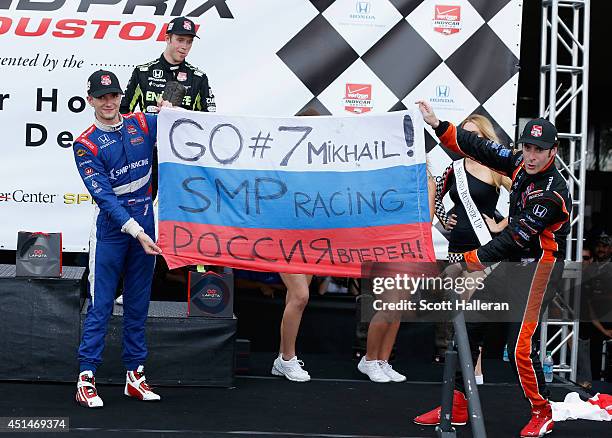 Simon Pagenaud of France, driver of the Schmidt Peterson Hamilton Motorsports Dallara Honda, poses on the podium with Mikhail Aleshin of Russia,...