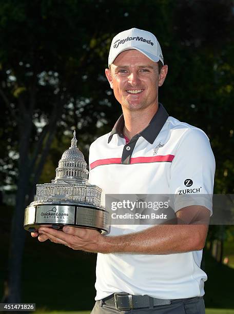 Justin Rose of England holds the trophy after winning the Quicken Loans National at Congressional Country Club on June 29, 2014 in Bethesda, Maryland.