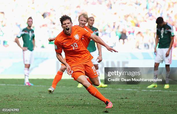 Klaas-Jan Huntelaar of the Netherlands celebrates scoring his team's second goal on a penalty kick in stoppage time during the 2014 FIFA World Cup...