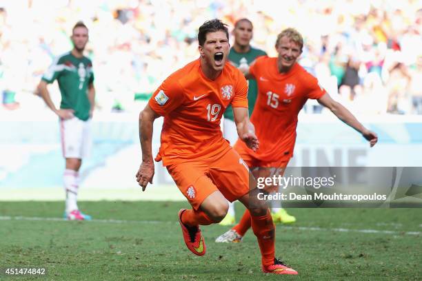 Klaas-Jan Huntelaar of the Netherlands celebrates scoring his team's second goal on a penalty kick in stoppage time during the 2014 FIFA World Cup...