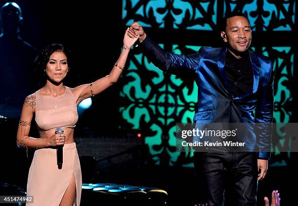 Singers Jhene Aiko and John Legend perform onstage during the BET AWARDS '14 at Nokia Theatre L.A. LIVE on June 29, 2014 in Los Angeles, California.