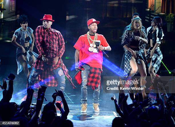 Singer Chris Brown and rapper Tyga perform onstage during the BET AWARDS '14 at Nokia Theatre L.A. LIVE on June 29, 2014 in Los Angeles, California.