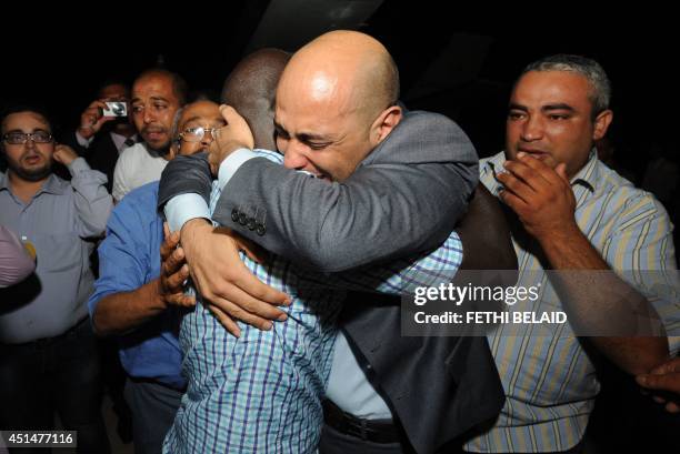 Tunisian diplomat Al-Aroussi Kontassi returns to his family on the tarmac at the military airport in Aouina on June 30, 2014 in Tunis. Al-Aroussi...