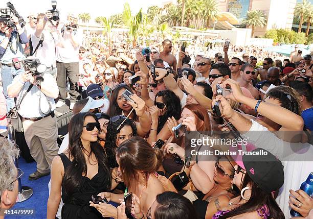 Kim Kardashian poses with fans at Wet Republic on April 24, 2010 in Las Vegas, Nevada.