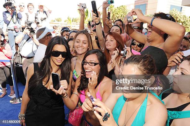Kim Kardashian poses with fans at Wet Republic on April 24, 2010 in Las Vegas, Nevada.