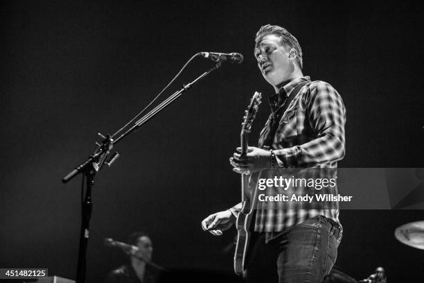 Josh Homme of Queens of The Stone Age performs on stage at Wembley Arena on November 22, 2013 in London, United Kingdom.