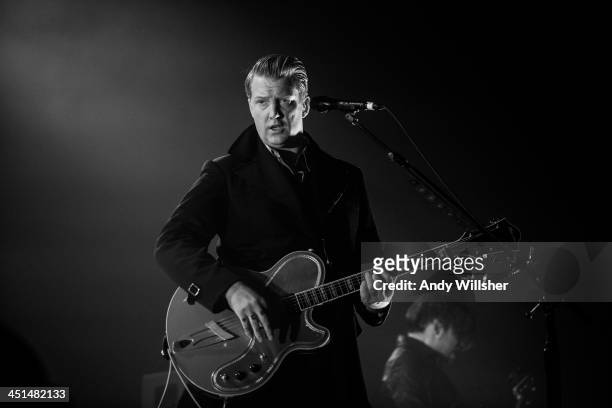 Josh Homme of Queens of The Stone Age performs on stage at Wembley Arena on November 22, 2013 in London, United Kingdom.