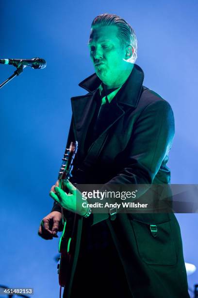 Josh Homme of Queens of The Stone Age performs on stage at Wembley Arena on November 22, 2013 in London, United Kingdom.