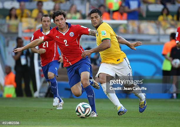 Hulk of Brazil and Eugenio Mena of Chile in action during the 2014 FIFA World Cup Brazil round of 16 match between Brazil and Chile at Estadio...