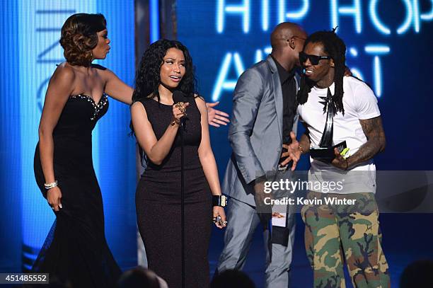 Singer/rapper Nicki Minaj accepts Best Female Hip-Hop Artist with rapper Lil Wayne onstage during the BET AWARDS '14 at Nokia Theatre L.A. LIVE on...