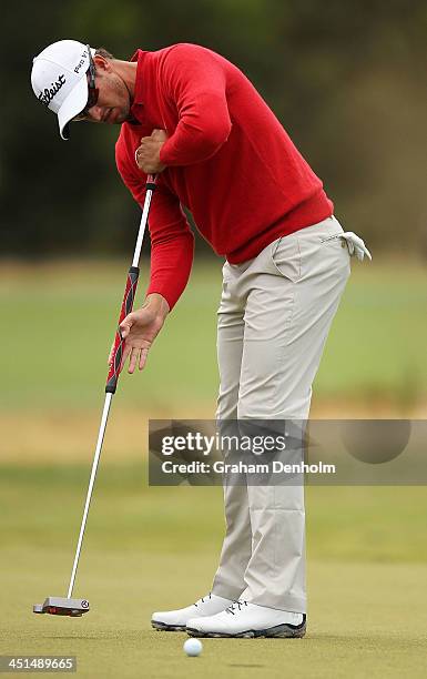 Adam Scott of Australia makes a putt during day three of the World Cup of Golf at Royal Melbourne Golf Course on November 23, 2013 in Melbourne,...