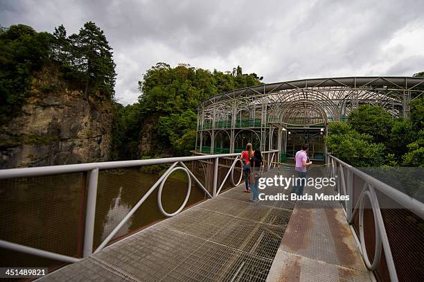 Tourists visit the Opera de Arame or the Wire Opera House, a theatre house built out of steel tubes situated in the middle of an urban green park,...