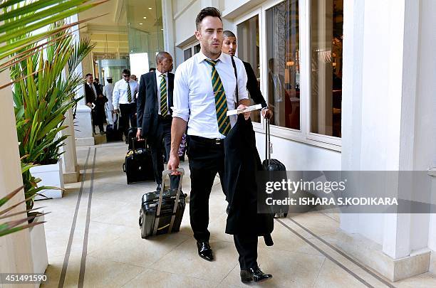 South African cricketers Faf du Plessis , Beuran Hendricks and Aaron Phangiso arrive at a hotel in Colombo on June 30, 2014. South Africa will play...