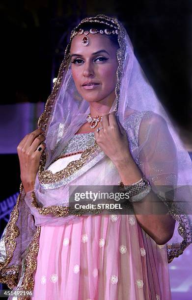 Indian Bollywood actress Neha Dhupia showcases a creation during the 'Indian Wedding Couture' fashion show in Mumbai on late June 29, 2014. AFP...