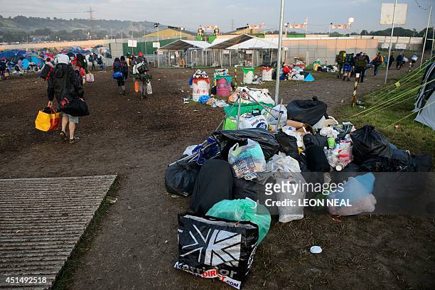 Tents, equipment and debris litter the camping fields on the morning after the Glastonbury Festival of Music and Performing Arts on Worthy Farm in...