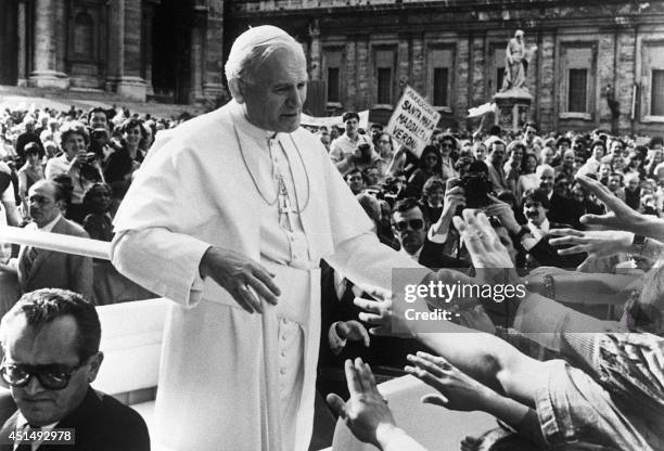 Pope John Paul II blesses followers a few seconds before being shot and seriously wounded 13 May 1981 at Saint Peter's square by a Turkish extremist...